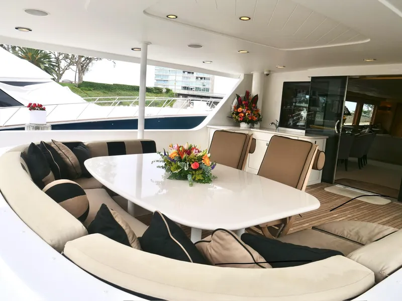 Slide: The Image of Luxurious 2000 Westport 112 yacht interior with elegant seating and dining area. - 12