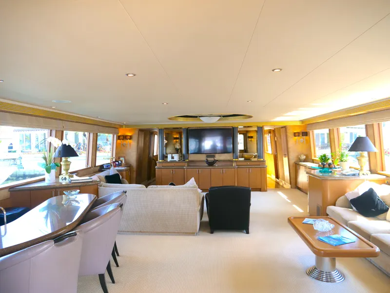 Slide: The Image of Luxurious interior of a 2000 Westport 112 yacht with elegant furnishings and large windows. - 13