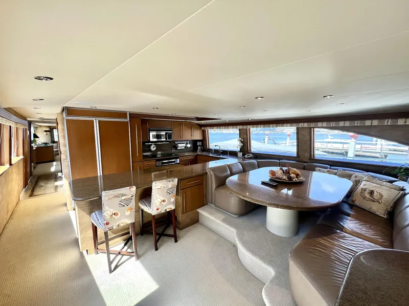 Slide: The Image of Luxurious interior of a 2000 Westport 112 yacht with modern kitchen and dining area. - 16