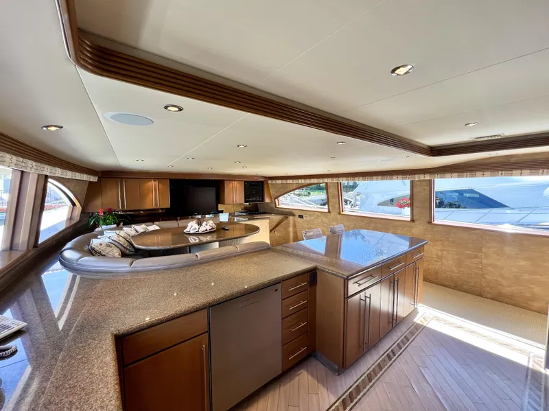Slide: The Image of Luxurious interior of 2000 Westport 112 yacht with elegant wood finishes and panoramic windows. - 18