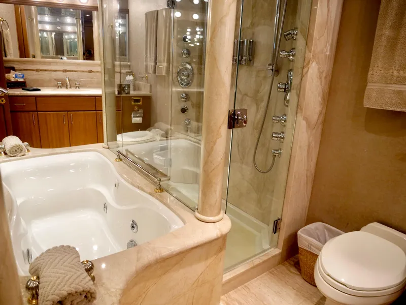 Slide: The Image of Luxurious bathroom in a 2000 Westport 112 yacht with jacuzzi and glass shower. - 26