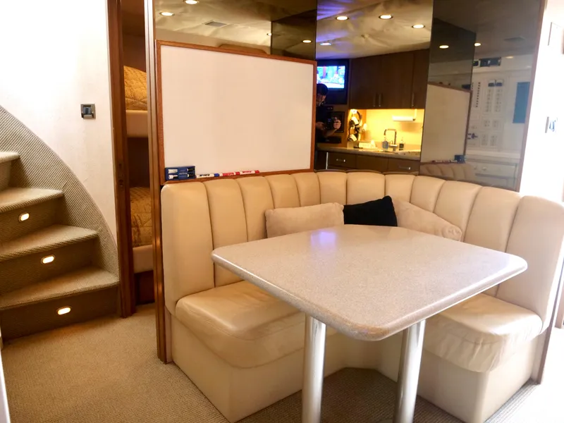 Slide: The Image of Luxurious dining area in a 2000 Westport 112 yacht with beige seating and modern decor. - 38