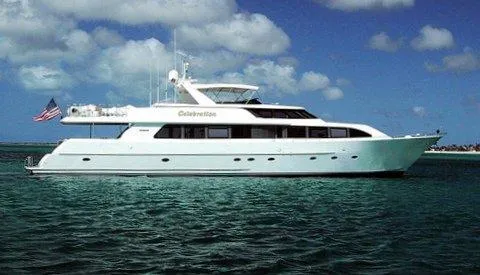 Slide: The Image of 2000 Westport 112 yacht cruising on clear blue waters under a partly cloudy sky. - 49