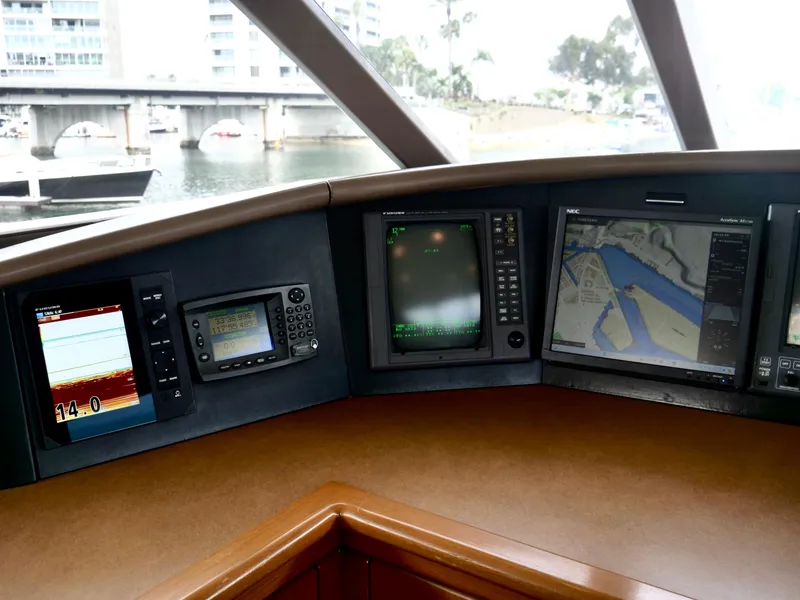 Slide: The Image of Westport 112 yacht helm with navigation screens, 2000 model, docked near marina. - 8