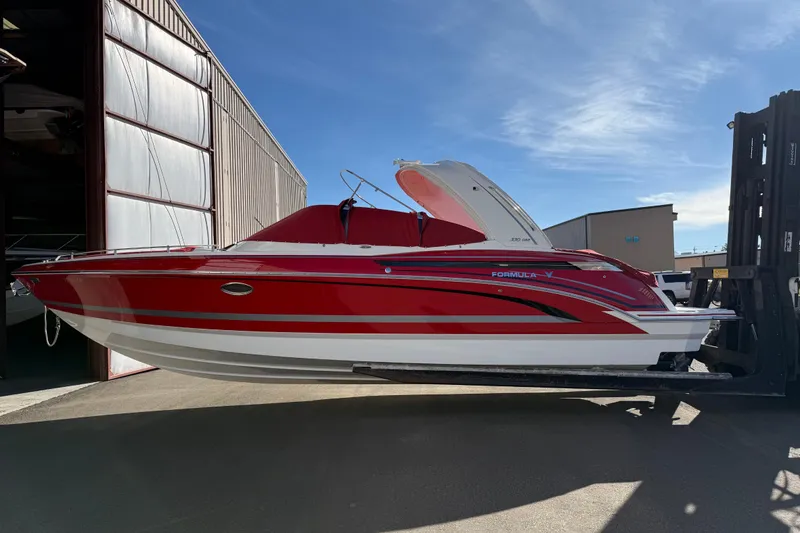 Slide: The Image of 2019 Formula 330 Crossover Bowrider interior with white seating and red accents. - 6