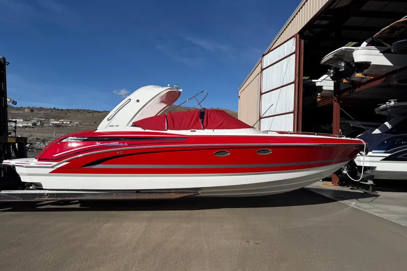 Slide: The Image of 2019 Formula 330 Crossover Bowrider interior with white seating and red accents. - 8