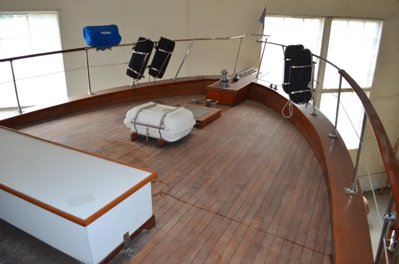 Slide: The Image of 1971 Matthews 56 Motor Yacht deck with wooden flooring and safety equipment. - 27