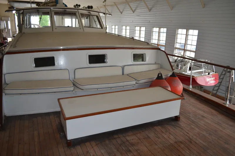 Slide: The Image of 1971 Matthews 56 Motor Yacht interior with seating and wooden flooring. - 28