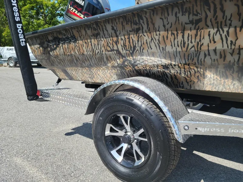 The Image of 2025 Xpress H20 Bass boat with Yamaha Vmax 150, camo design, on trailer. - 1