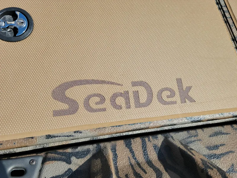 Slide: The Image of SeaDek flooring on Xpress H20 Bass boat, featuring a textured tan surface. - 5