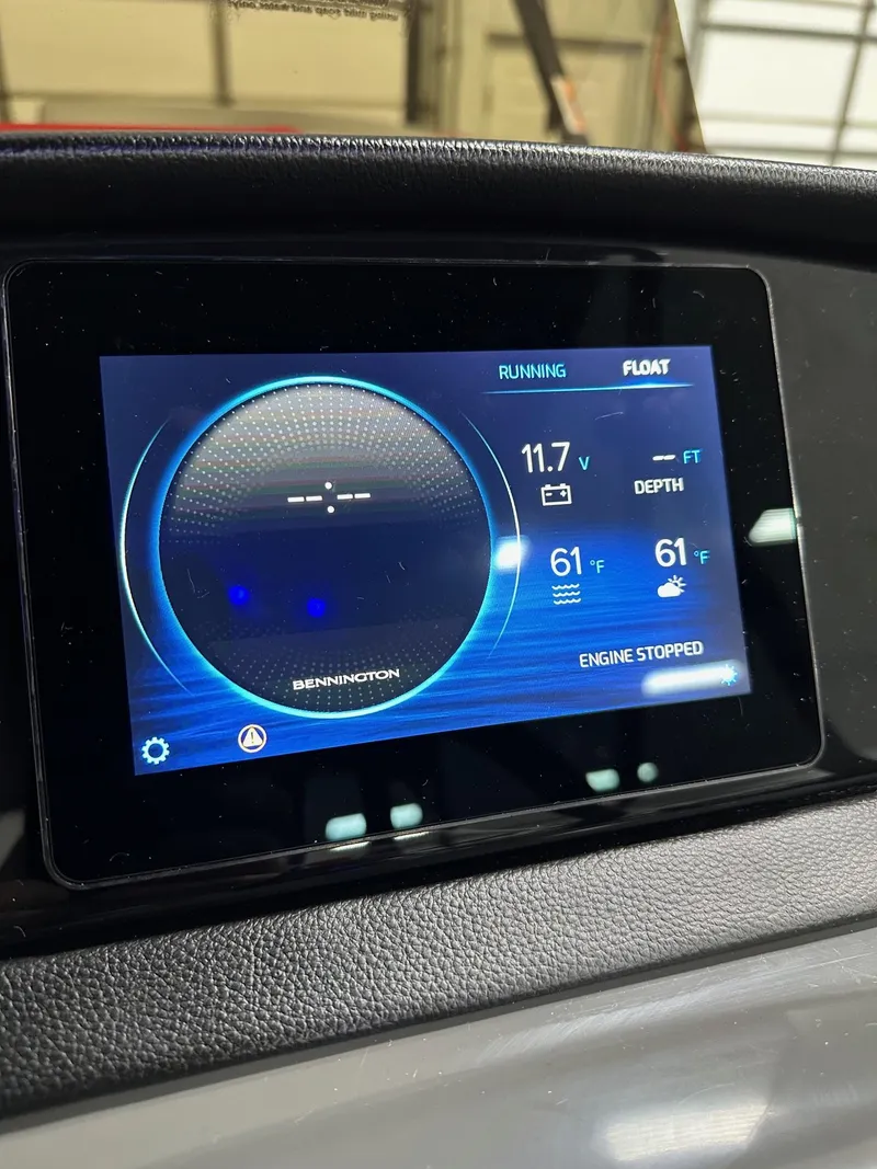 Slide: The Image of Dashboard display of 2025 Bennington 21 SSR Quad Bench, showing engine status and depth. - 10