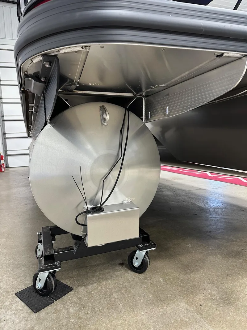 Slide: The Image of 2025 Bennington 21 SSR Quad Bench pontoon underside on wheeled stand in garage. - 18