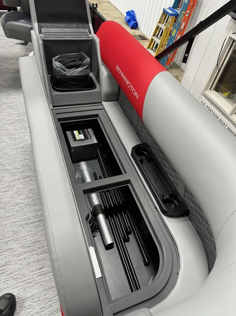 Slide: The Image of 2025 Bennington 21 SSR Quad Bench interior storage compartment with accessories. - 27