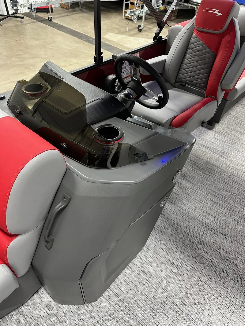Slide: The Image of 2025 Bennington 21 SSR Quad Bench interior with red and gray seating, steering console. - 7
