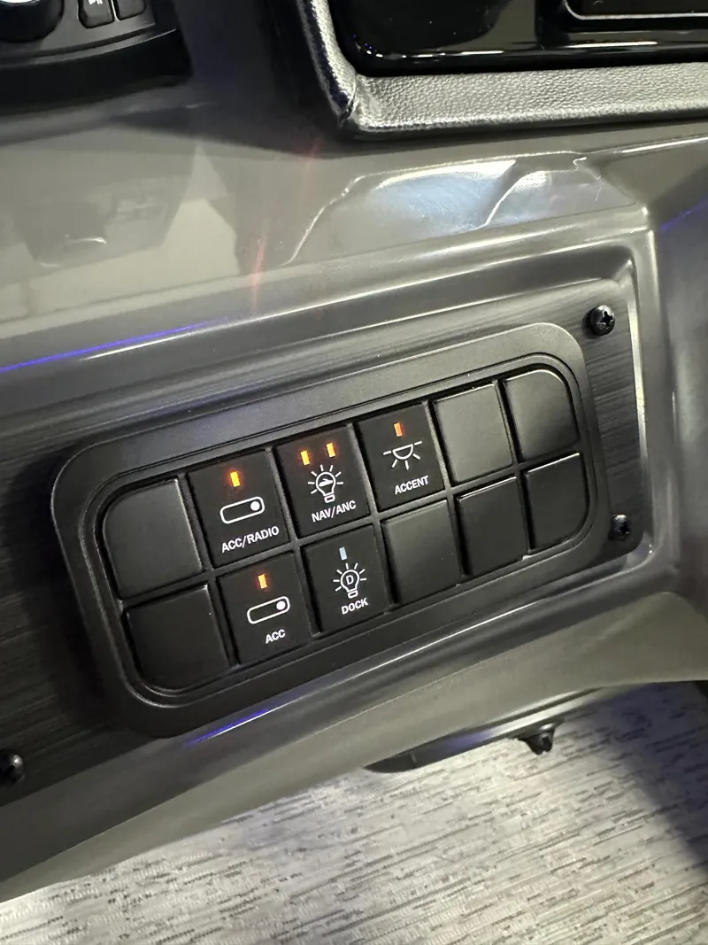 Slide: The Image of Control panel of 2025 Bennington 21 SSR Quad Bench boat, featuring various switches. - 8