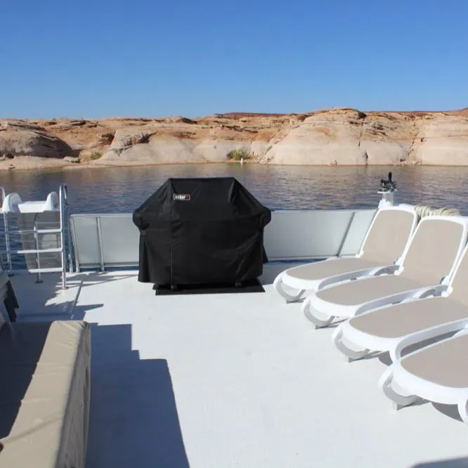 Slide: The Image of Deck of Adonia Atlantis Trip 8 houseboat with lounge chairs and grill, 2016. - 10