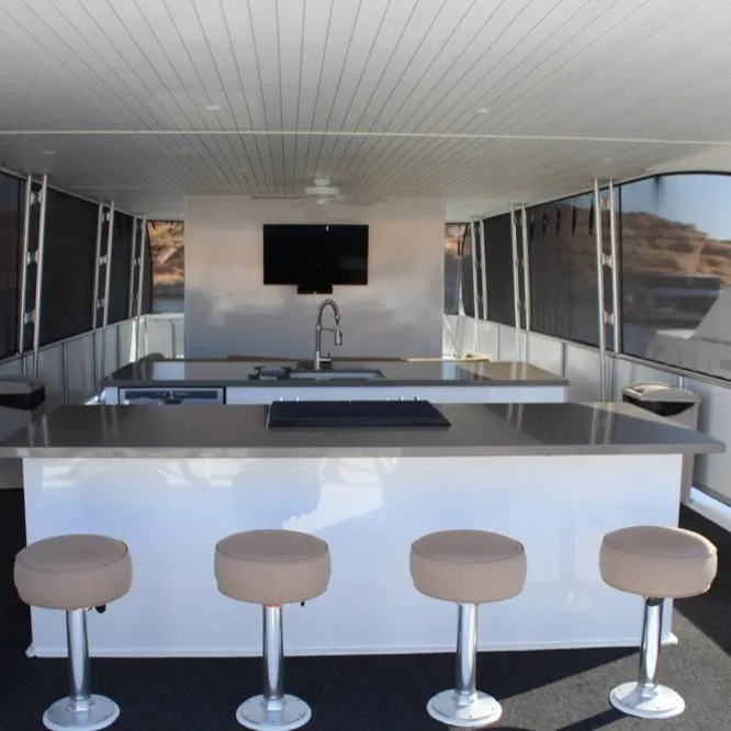 Slide: The Image of Modern kitchen area on Adonia Atlantis Trip 8 houseboat, featuring bar stools and a TV, 2016 model. - 3