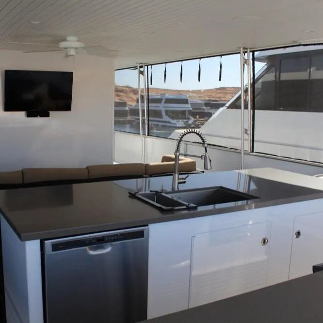Slide: The Image of Modern kitchen interior on Adonia Atlantis Trip 8 yacht, 2016 model, featuring sleek countertops and appliances. - 4