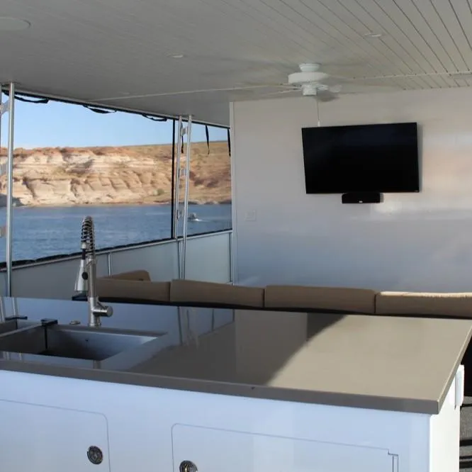 Slide: The Image of Luxurious Adonia Atlantis Trip 8 yacht interior with TV, sink, and scenic water view. - 5