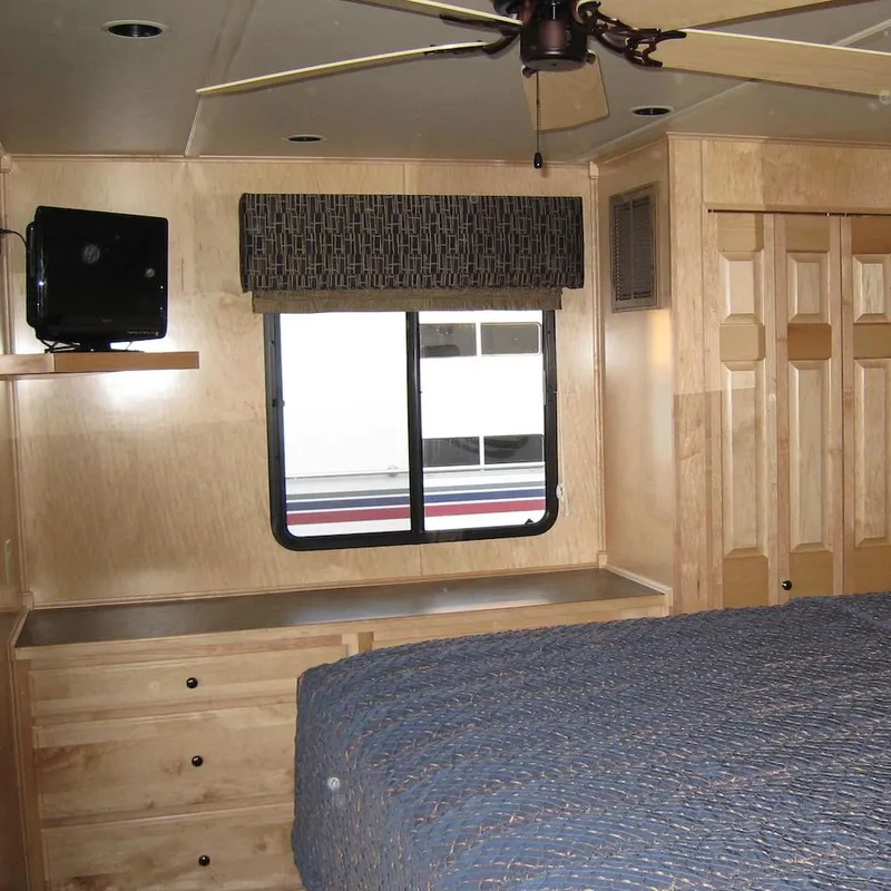 Slide: The Image of Interior of 2009 Sumerset Stargazer Trip 10 with bed, window, and wooden cabinetry. - 15