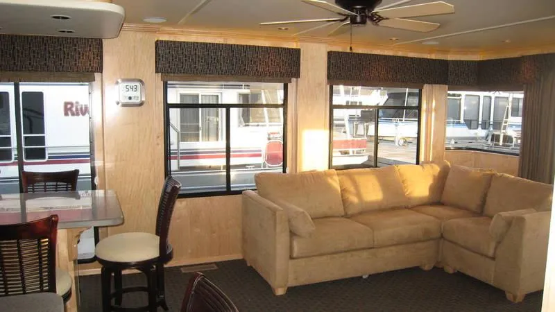 Slide: The Image of Interior of 2009 Sumerset Stargazer Trip 10 houseboat with beige sofa and dining area. - 4