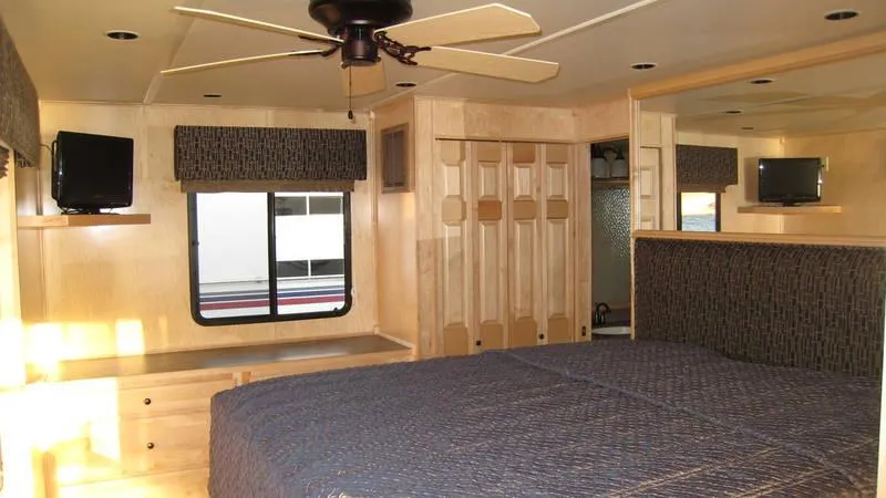 Slide: The Image of Interior of 2009 Sumerset Stargazer Trip 10 houseboat with bed, ceiling fan, and TV. - 5
