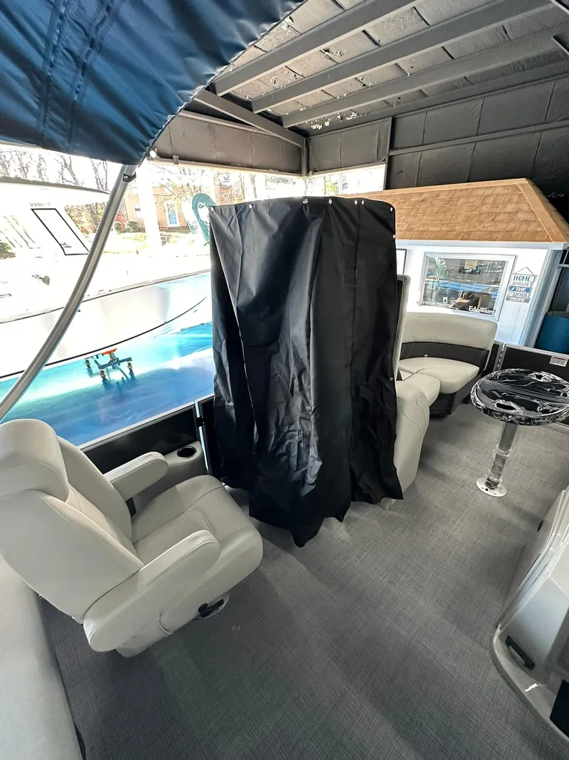 Slide: The Image of 2025 Sylvan Mirage 8520 CLZ DH interior with seating and covered area. - 11