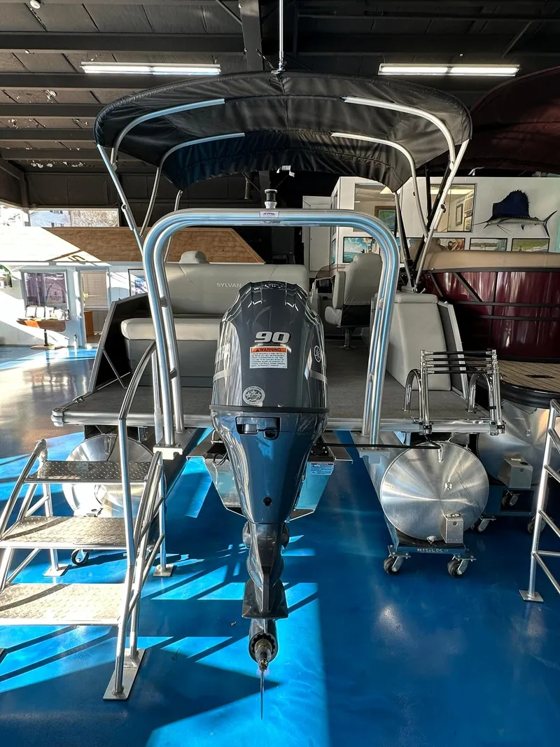 Slide: The Image of 2025 Sylvan Mirage 8520 CLZ DH pontoon boat with outboard motor in showroom. - 3