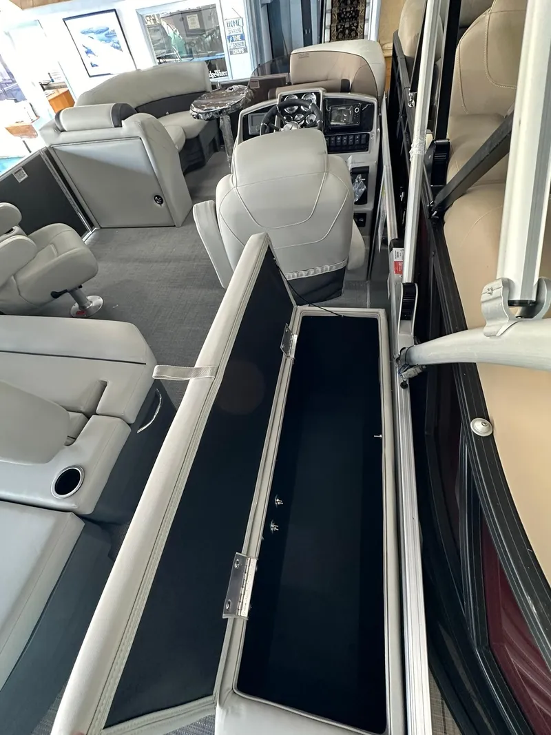 Slide: The Image of 2025 Sylvan Mirage 8520 CLZ DH interior with seating and storage features. - 9