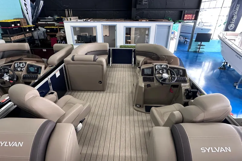 Slide: The Image of 2026 Sylvan Mirage 8522 LZ pontoon boat interior with luxurious seating and modern dashboard. - 16
