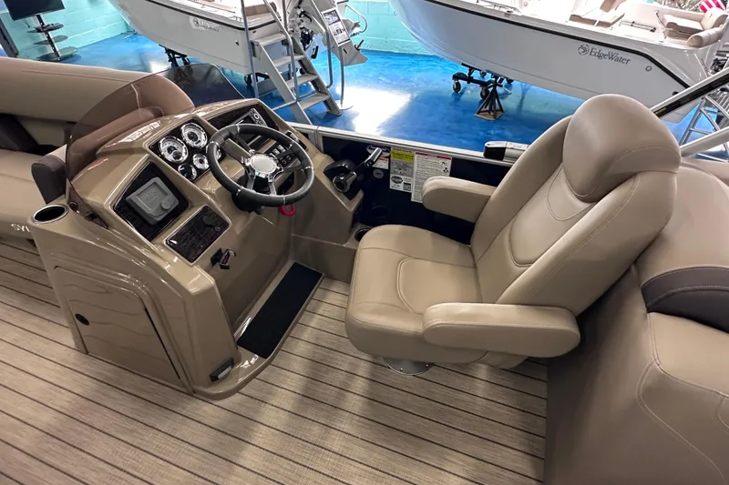 Slide: The Image of 2026 Sylvan Mirage 8522 LZ boat interior with steering console and captain's chair. - 19