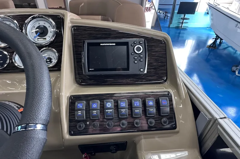 Slide: The Image of Dashboard of 2026 Sylvan Mirage 8522 LZ with Humminbird Helix 5 and control switches. - 22