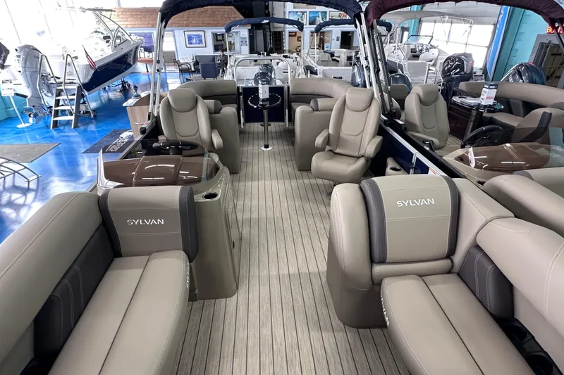 Slide: The Image of 2026 Sylvan Mirage 8522 LZ pontoon boat interior with luxurious seating in showroom. - 29