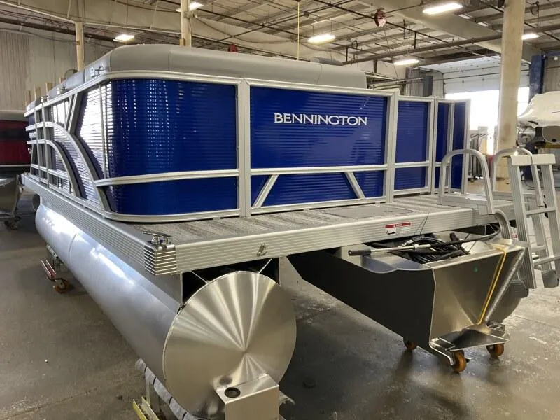 Slide: The Image of 2025 Bennington 168 SL pontoon boat in a warehouse setting. - 18