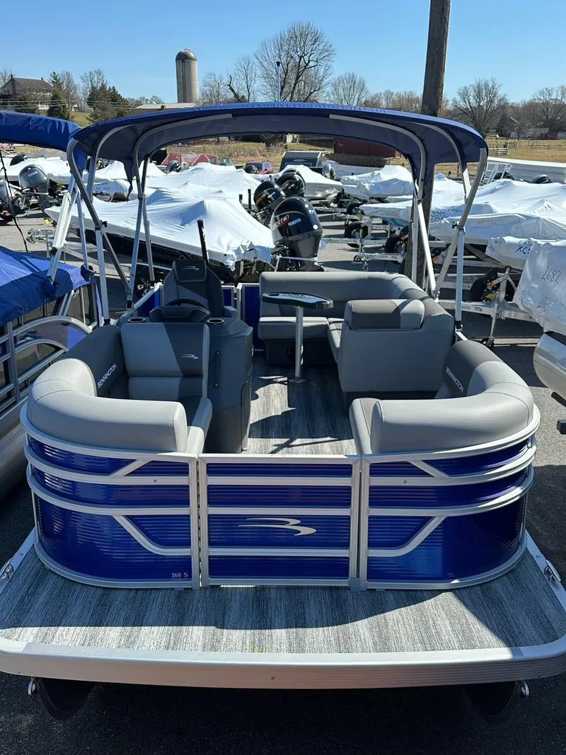 Slide: The Image of 2025 Bennington 168 SL pontoon boat with blue exterior and spacious seating. - 23