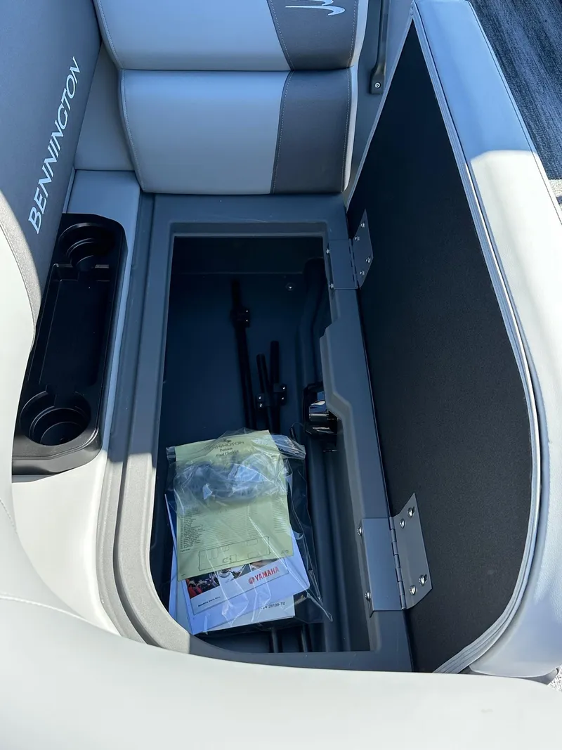 Slide: The Image of 2025 Bennington 168 SL boat storage compartment with documents and accessories. - 24