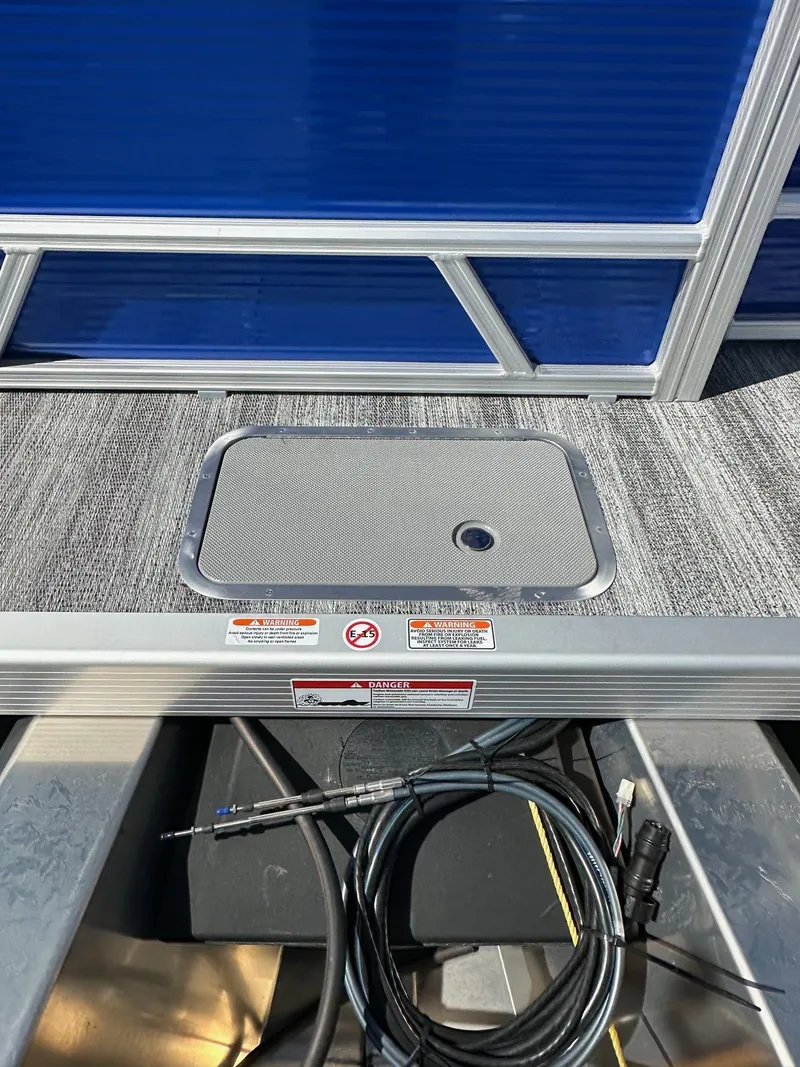 Slide: The Image of 2025 Bennington 168 SL pontoon deck with storage hatch and cables. - 27