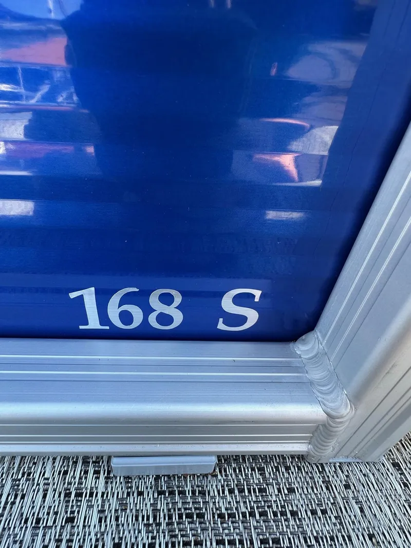 Slide: The Image of Close-up of Bennington 168 SL boat model, 2025, with blue and silver detailing. - 28