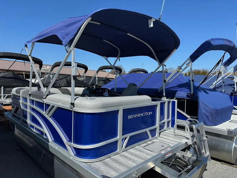 Slide: The Image of 2025 Bennington 168 SL pontoon boat with blue canopy, in stock. - 3