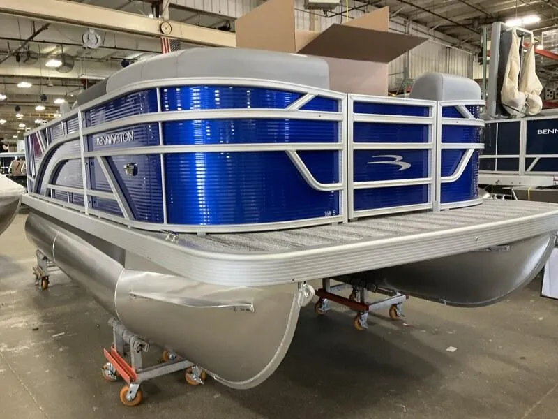 Slide: The Image of 2025 Bennington 168 SL pontoon boat in stock, displayed in a showroom. - 35