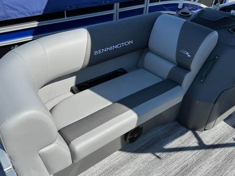 Slide: The Image of 2025 Bennington 168 SL boat seating, gray upholstery, cup holders, and logo detail. - 5