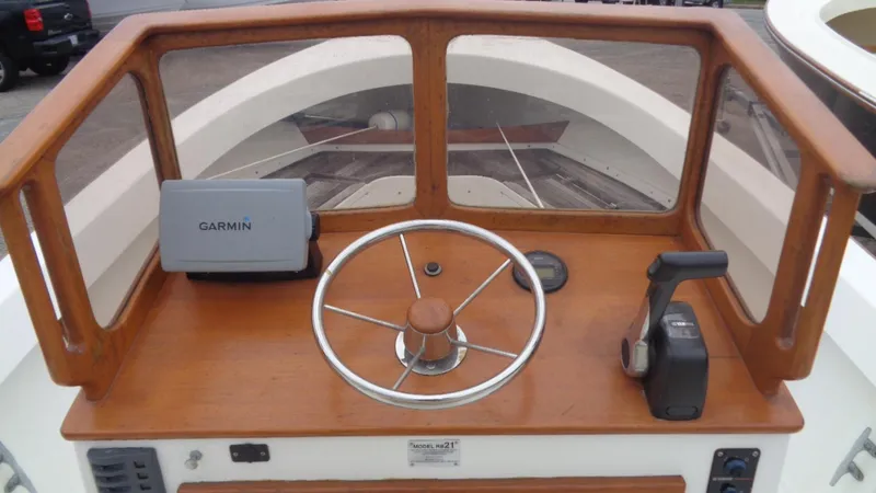 Slide: The Image of 2008 Roth Bilt 21 Classic boat dashboard with Garmin GPS and wooden steering wheel. - 12