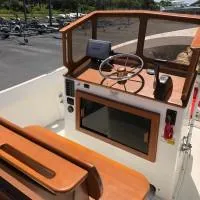 Slide: The Image of 2008 Roth Bilt 21 Classic boat cockpit with wooden dashboard and steering wheel. - 6