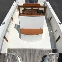 Slide: The Image of 2008 Roth Bilt 21 Classic boat interior with wooden accents and steering console. - 8
