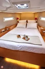 Slide: The Image of 2024 Jeanneau Sun Odyssey 410 cabin interior with cozy bed and modern design. - 8