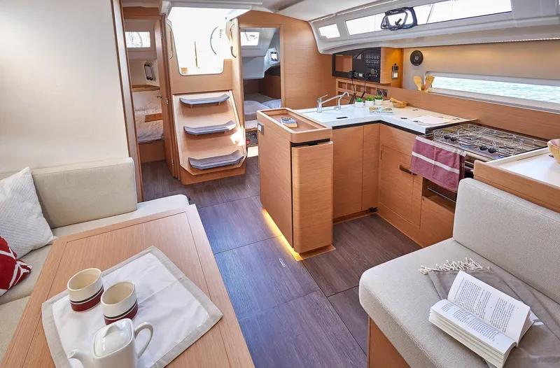 Slide: The Image of Interior of 2024 Jeanneau Sun Odyssey 410 yacht, featuring modern kitchen and cozy seating area. - 9