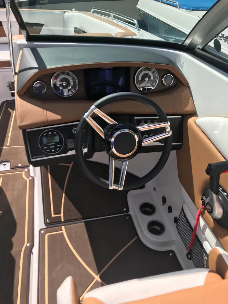 Slide: The Image of Interior view of 2019 Four Winns HD270 boat cockpit with steering wheel. - 11