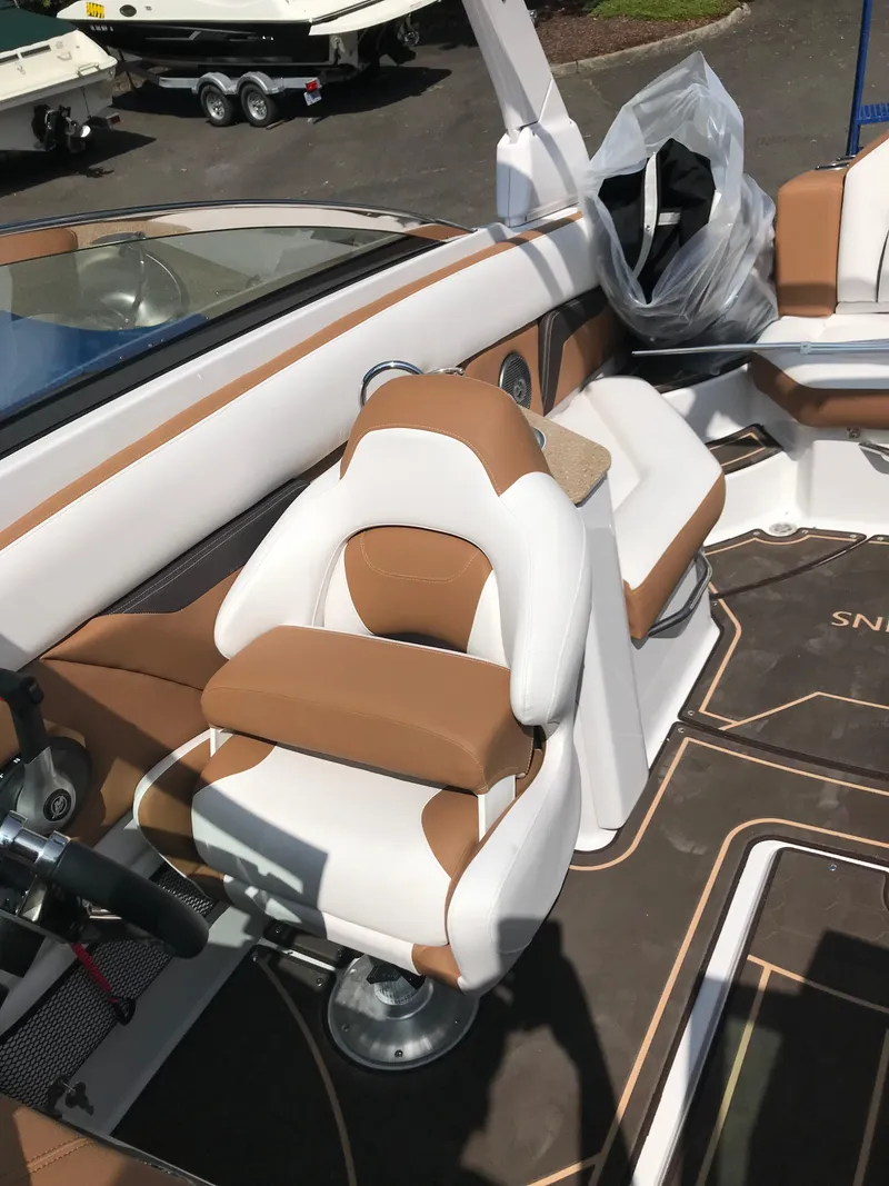Slide: The Image of Interior of a 2019 Four Winns HD270 boat with brown and white seating. - 13
