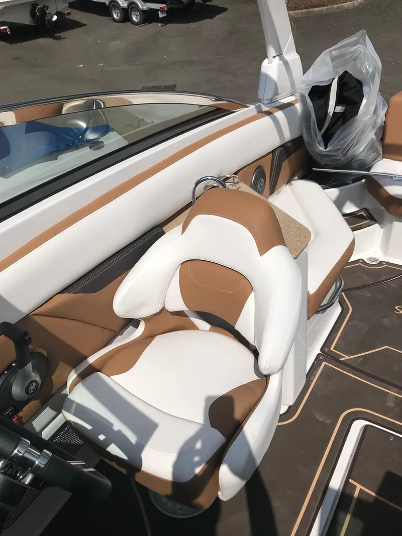 Slide: The Image of Interior of a 2019 Four Winns HD270 boat with brown and white seating. - 14