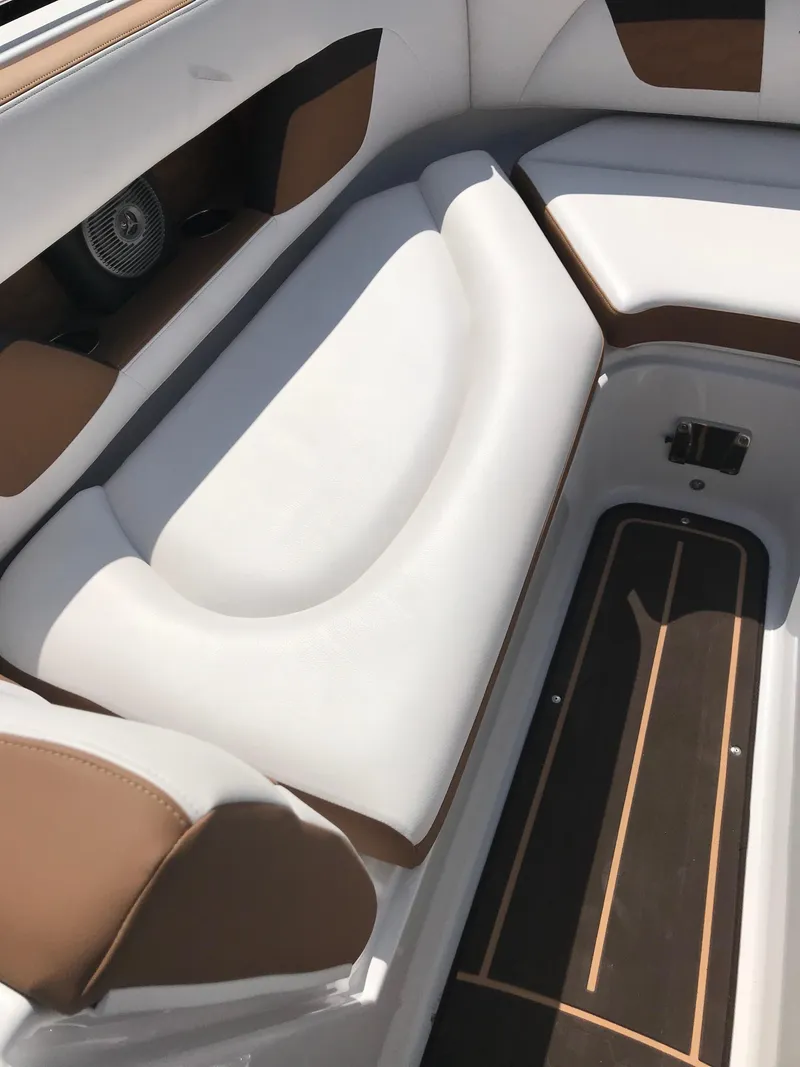 Slide: The Image of Interior of a 2019 Four Winns HD270 boat with white and brown seating. - 17